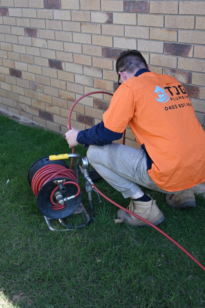 plumbing using drain camera in backyard of blocked drain