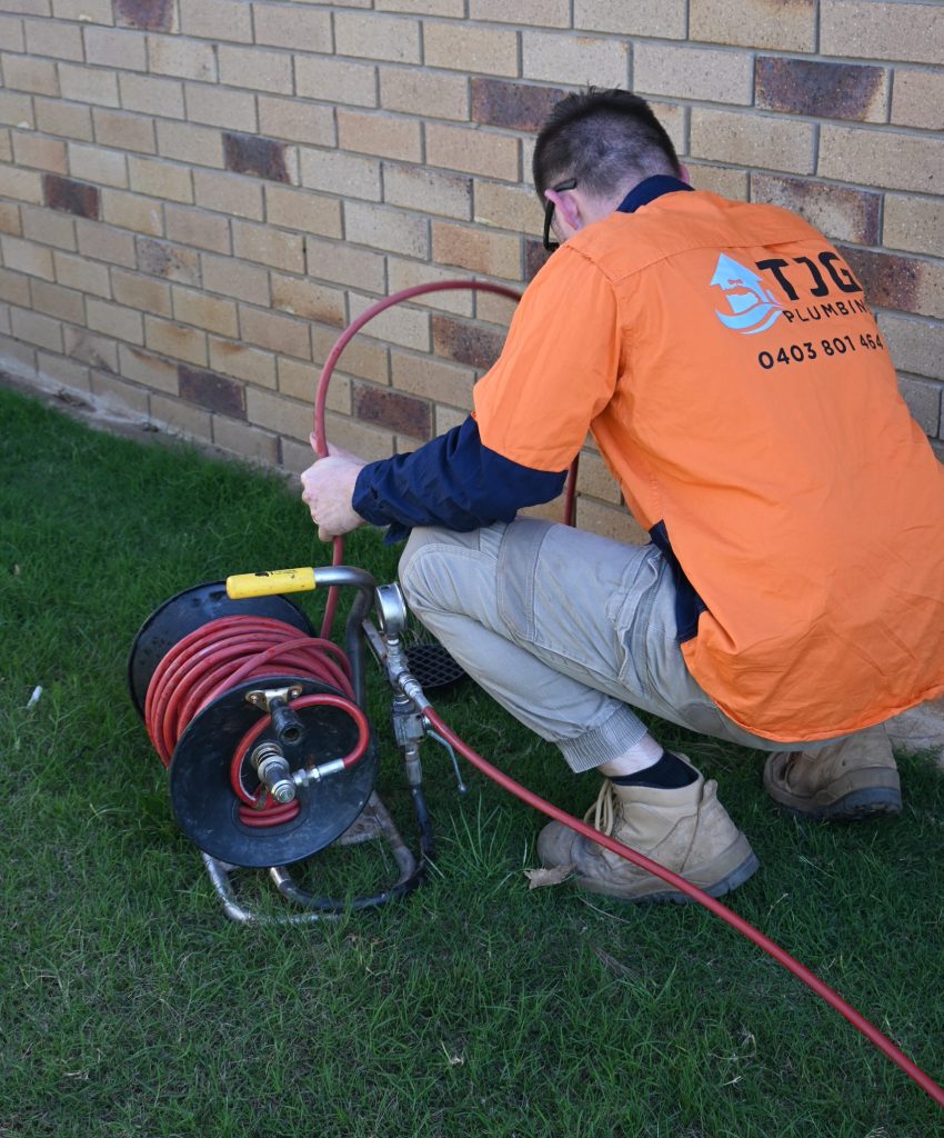 plumbing using drain camera in backyard of blocked drain