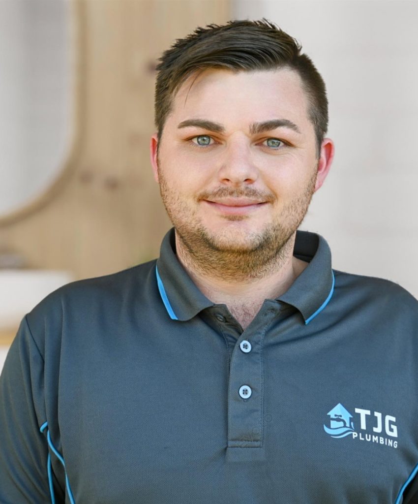 Young professional plumber in grey uniform for the About Us page